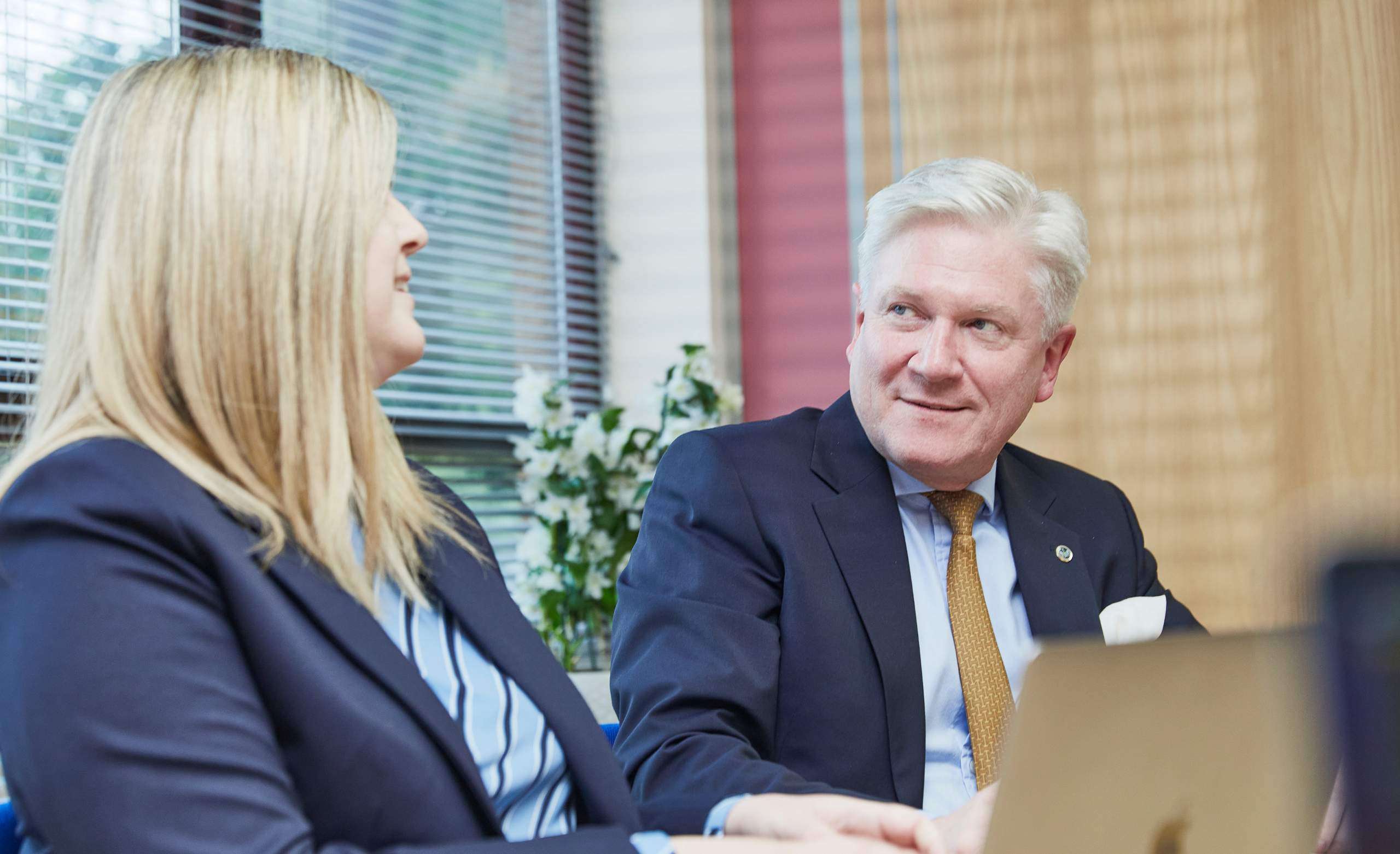 Male and female solicitors in meeting with client